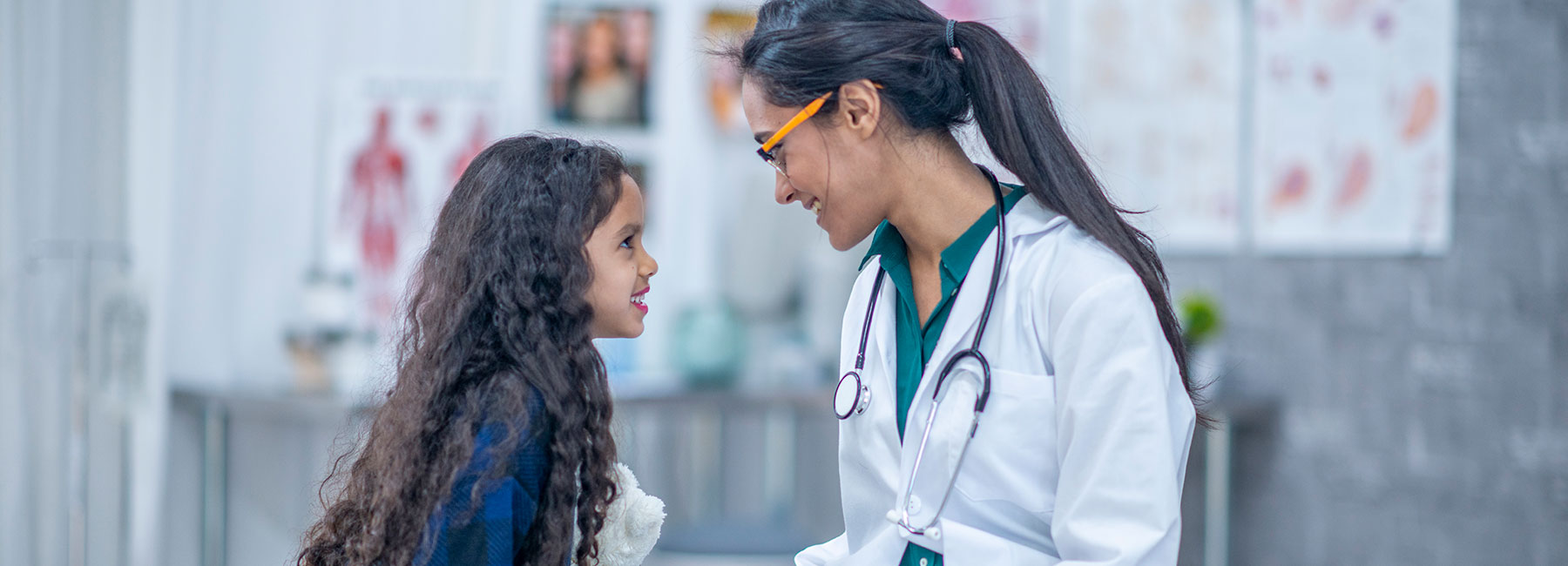 A doctor chats with a young girl